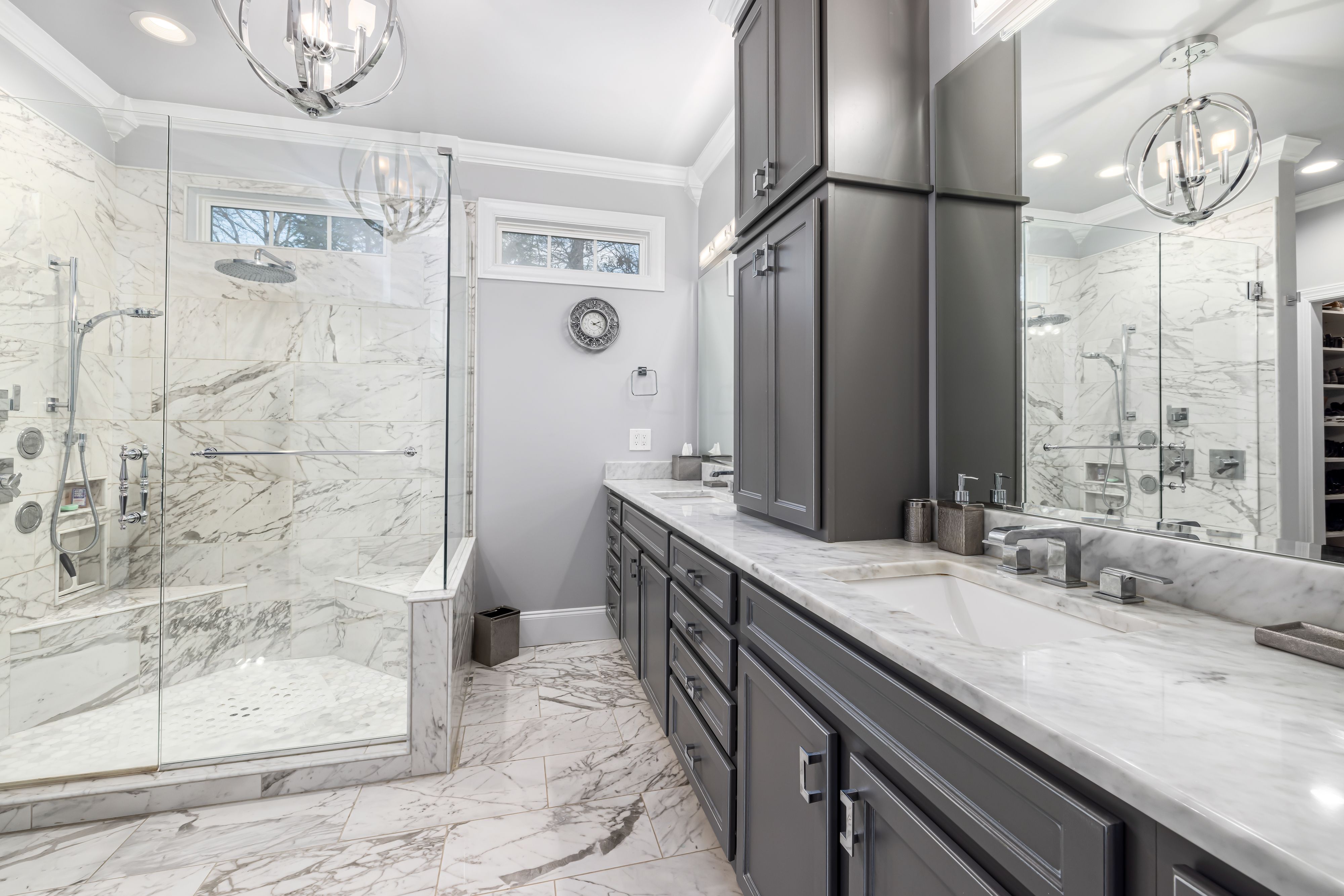 Renovated bathroom with stone surfaces and warm brass fixtures