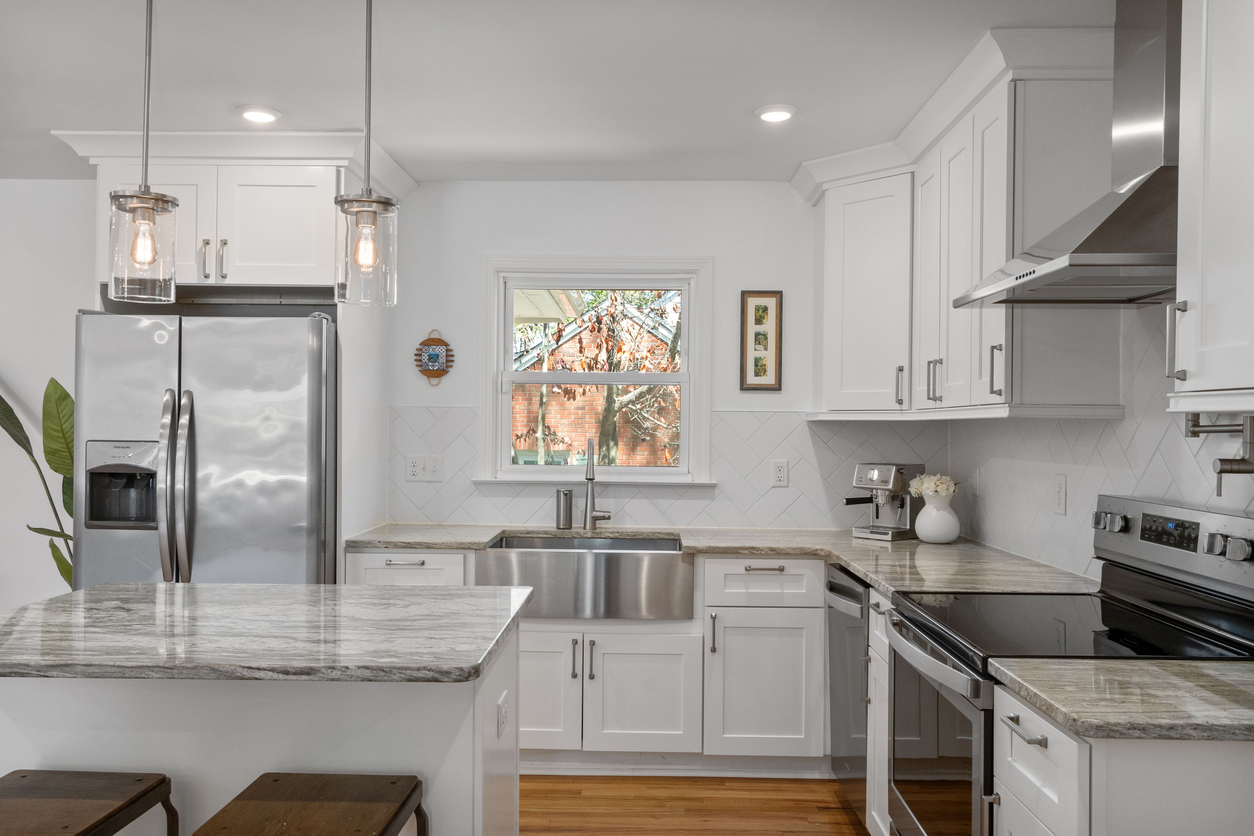 Renovated kitchen with marble surfaces and integrated cabinetry